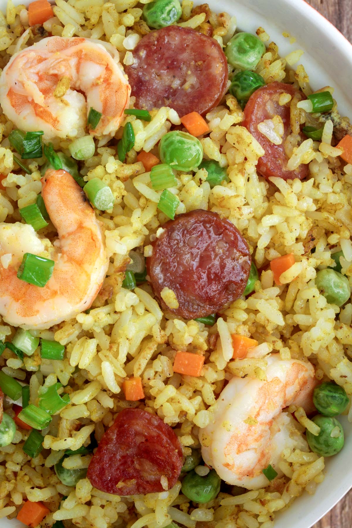 Yang Chow fried rice  loaded with shrimp, sausages, eggs, carrots, and green peas.